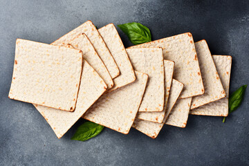 Matzoh jewish holiday bread. Traditional ritual Jewish bread. Top view, on a gray background.