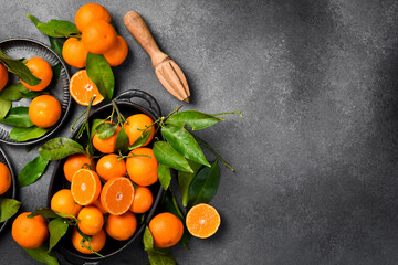 Close-up, Tangerines (oranges, clementines, citrus fruits). On a gray stone background. Free space for design or text.