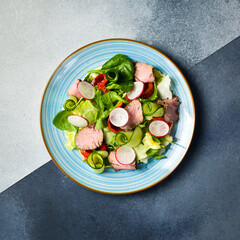 Salad with veal, spinach and radish. Close up.