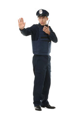 Young policeman in uniform with walkie talkie showing stop gesture on white background