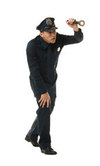 Young policeman in uniform with flashlight on white background