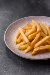 French fries are salty, crispy, and fried in oil, unhealthy takeaway food. French fries
