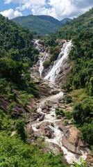 Vertical shot of a rushing waterfall cascading down a rocky mountain