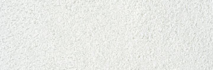 Close-up texture of soft white terry cloth towel fabric background.