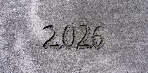 Business concept of 2026 new year symbol. Concept 2026 happy new year written on beautiful ocean sand beach. Beautiful ocean sand beach background, copy space. Business 2026 happy new year concept.