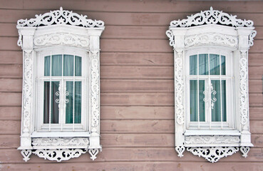 Two windows with antique shutters in a Russian city