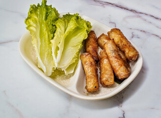 Crispy Vietnamese Imperial Rolls with Fresh Lettuce on Marble Background top view of hong kong food