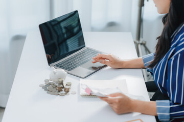Financial Focus: An individual carefully manages finances, examining documents and working on a...