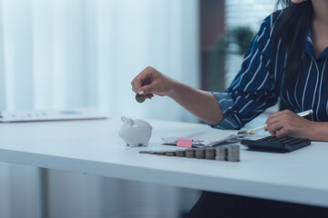 Savings and Finances: A person meticulously drops a coin into a piggy bank, representing financial...