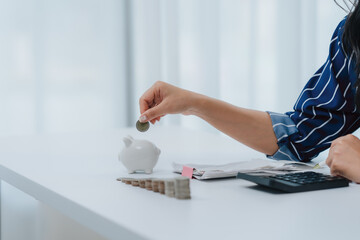 Saving for the Future: A person invests in their financial well-being, carefully depositing a coin into a piggy bank, symbolizing prudent money management and financial security.