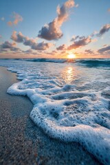 Beautiful sunset over the ocean with gentle waves lapping at the shore during golden hour on a clear day in a tropical location