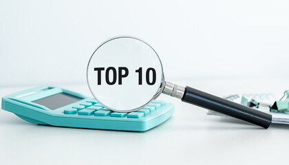 A calculator and a magnifying glass with the word Top 10 written on it