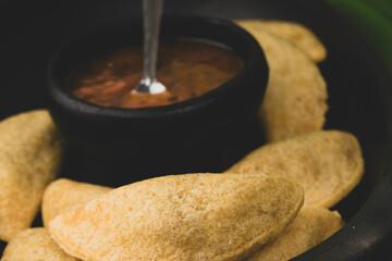 Colombian empanada with spicy sauce 