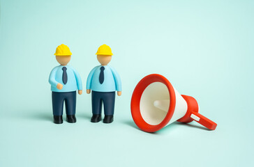 Two construction workers and a megaphone. Construction recruitment. Warnings regarding construction work and demolition operations. Labor safety and industrial communication