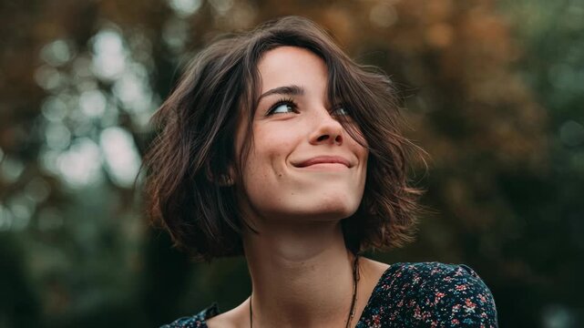 This portrait captures a young woman's joyful expression, suggesting optimism and contemplation