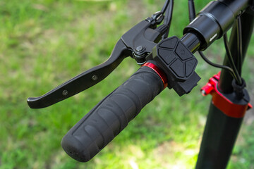 Electric scooter handlebar with brake lever and control pad close-up