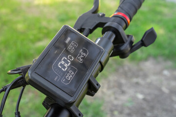 Electric scooter handlebar with digital display and brake lever close-up