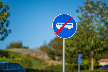 Blue circular road sign no bus allowed.