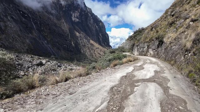 Huaraz, Peru: Panoramic footage of offroad on the way to laguna paron in border of Huascaran national park in Peru. Surrounded by high and cloudy mountains, showing majestic landscape