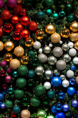 Colorful collection of Christmas Balls useful as a background pattern. Different Christmas balls on green background. Copy space.