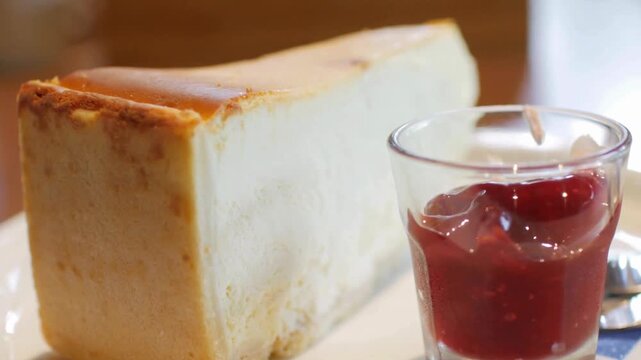 Cheesecake with Strawberry Sauce &ndash; Delicious Dessert Slice Served on Plate, Sweet Food and Beverage Concept with Dolly Shot Movement in 4K Ultra HD, Apple ProRes Quality
