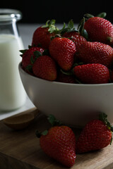 Glass full of strawberries and a glass of milk