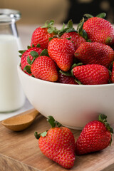 Glass full of strawberries and a glass of milk