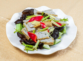 Stir Fry Fish Cake with Wood Ear Mushrooms, Celery, and Red Pepper on a White Plate high angle view of of Chinese cuisine