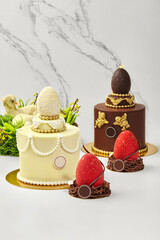 Easter cakes decorated with chocolate eggs and gold details representing traditional symbols