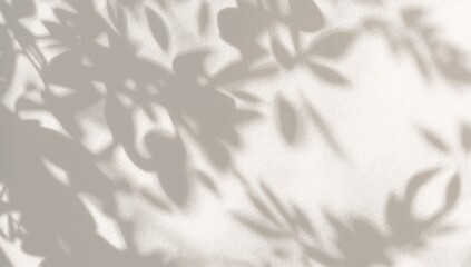 Dreamy sunlight casting elegant leaf shadows across a serene textured wall