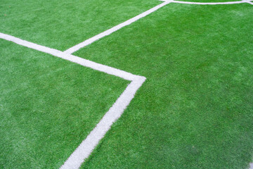 Obraz premium green artificial grass turf with white line for sports field background texture