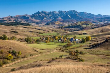 Obraz premium Scenic landscape featuring a village nestled in a valley, backed by mountains