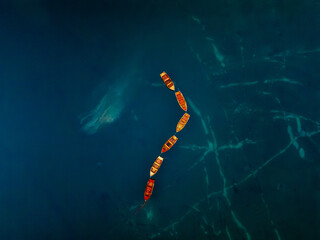 An Abstract Aerial View Showcasing the Beautiful Colorful Boats on the Deep Blue Water