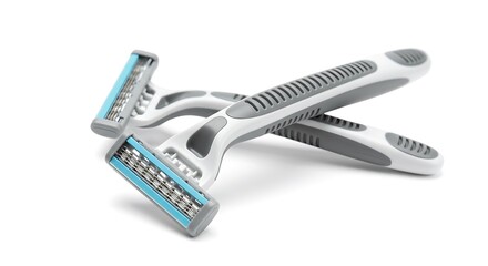 Two white and gray razors crossed isolated on white background