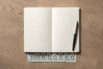 Financial Planning Concept with Notebook and Cash