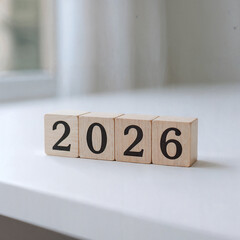 Wooden blocks spell out the year 2026 in a close up studio shot