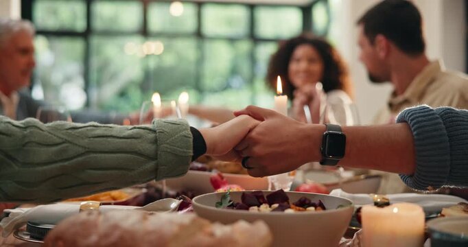 Thanksgiving, holding hands and prayer with family in dining room for festive holiday, celebration and tradition. Faith, gratitude and nutrition with food and people in home for feast and support