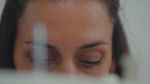 CloseUp of Woman Focused on Sewing Work