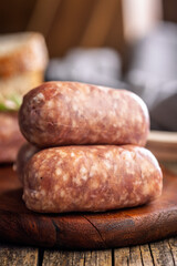 Photo of italian sausage salsiccia on cutting board on wooden table.