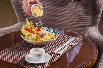 Fresh Caesar salad served with cheese, cup of creamy dressing.