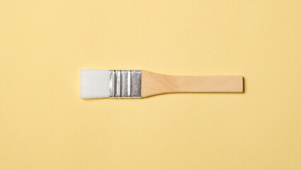 One new big size flat paintbrush is for painting, crafting, art projects, and detailed hobby work. Tool of artist. New brush. Drawing tassel top view. High quality photo