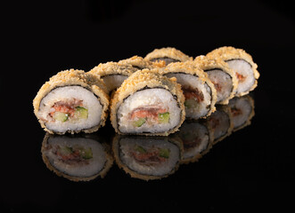 Baked salmon sushi rolls with cucumber, crispy topping, nori seaweed on a reflective surface
