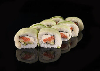 Philadelphia Green rolls with cucumber, salmon, and avocado on a reflective surface