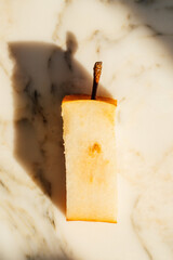 core of Asian pear with shadow on white marble