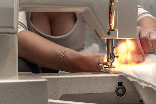 Sewing fabric bouncle on a sewing machine at home workshop