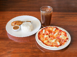 Pizza with fried chicken rice gravy and iced tea