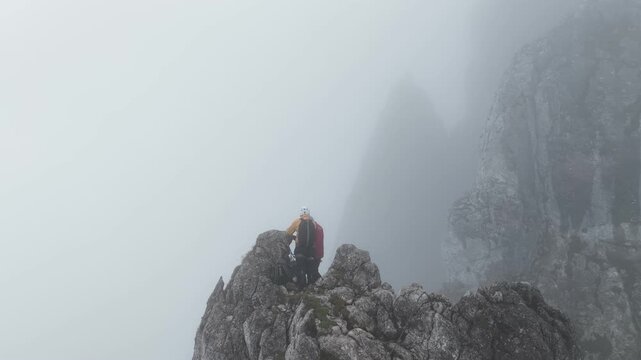 Mountaineers reaching a foggy rocky summit, Dachstein, Austria