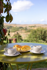 Autumn morning in Tuscany, coffee and focaccia under vineyard shade
