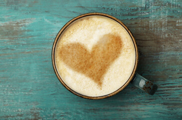 Cappuccino coffee cup on grunge blue table surface