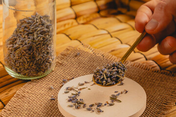Hand Scooping Dried Lavender Buds for Herbal Tea
